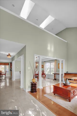 a dining room with furniture a chandelier and window