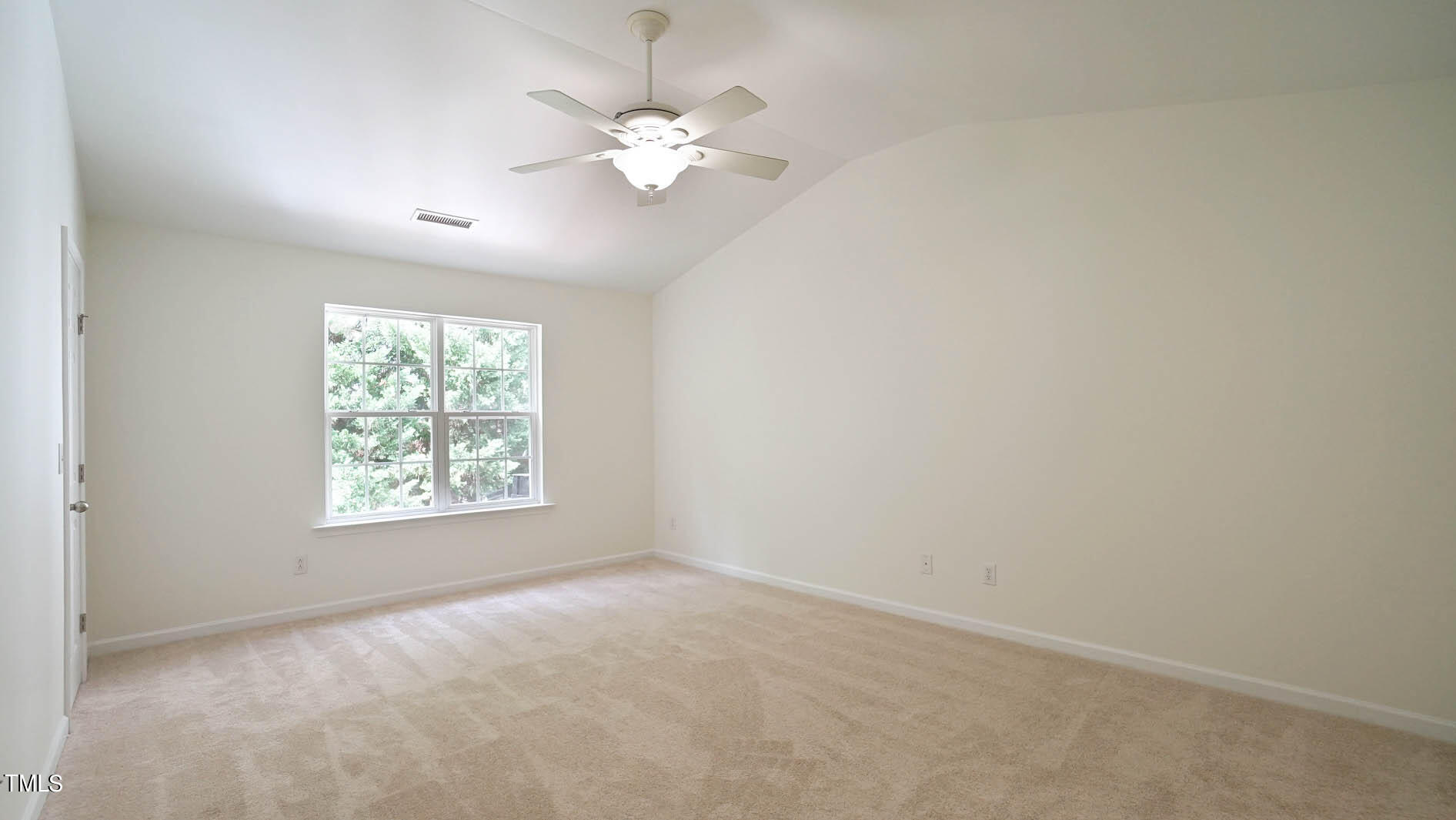 8215 Martello Lane Raleigh, NC 27613 - Photo 16 of 19 an empty room with a chandelier fan and windows