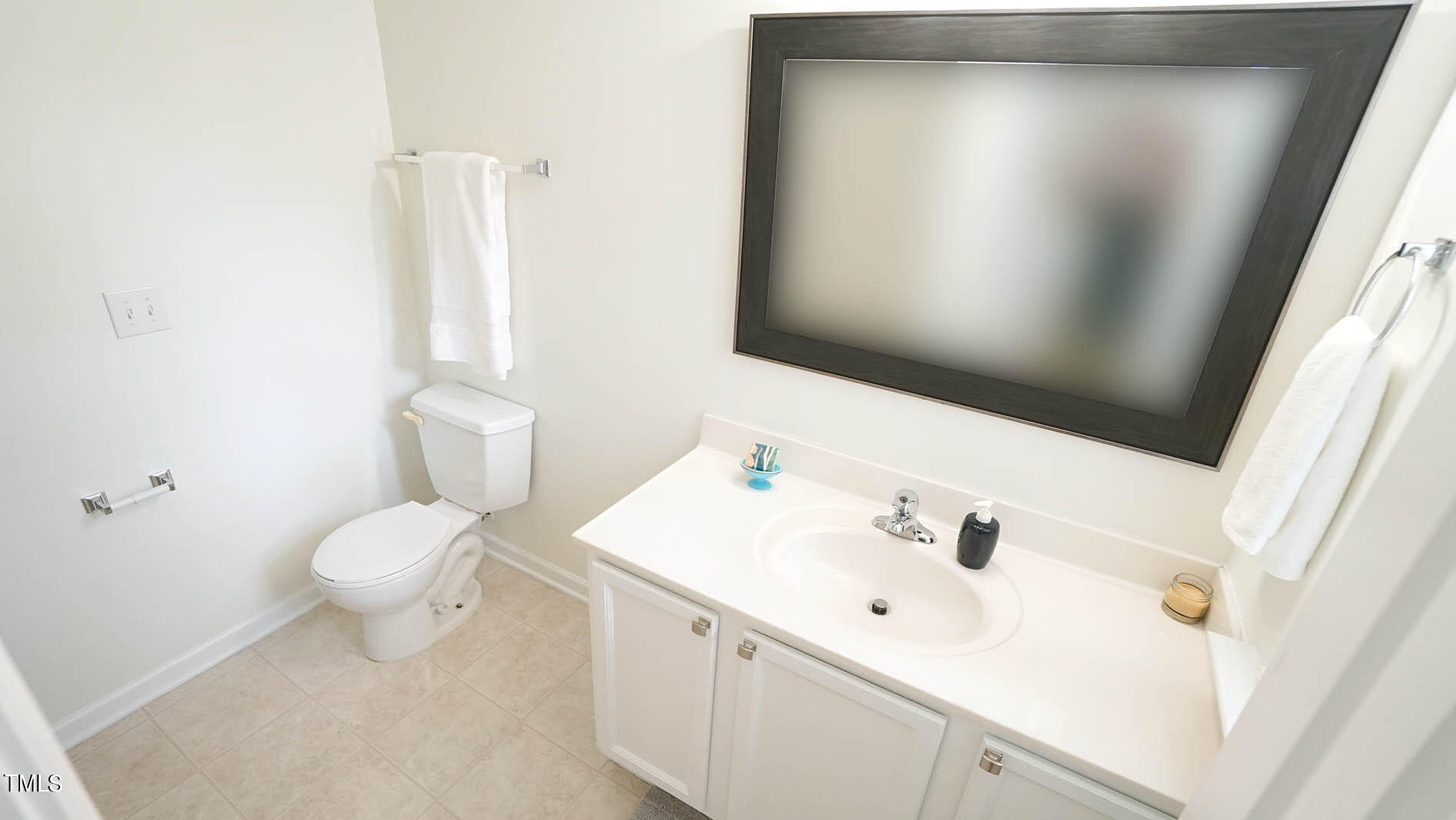 8215 Martello Lane Raleigh, NC 27613 - Photo 17 of 19 a bathroom with a sink a toilet and a mirror