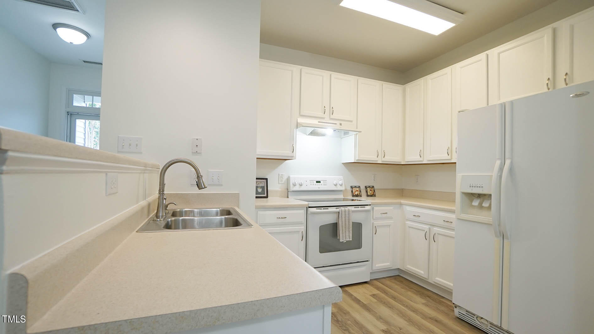 8215 Martello Lane Raleigh, NC 27613 - Photo 4 of 19 a kitchen with a sink a stove and refrigerator
