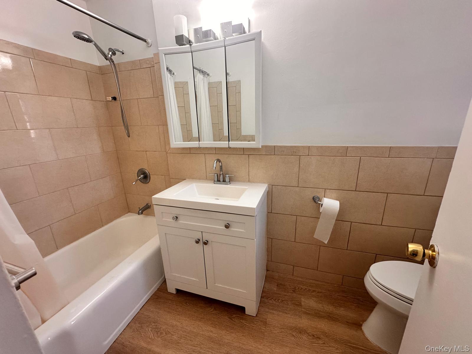150-11 72nd Road, Unit 6F Queens, NY 11367 - Photo 22 of 31 a bathroom with a sink a toilet and shower
