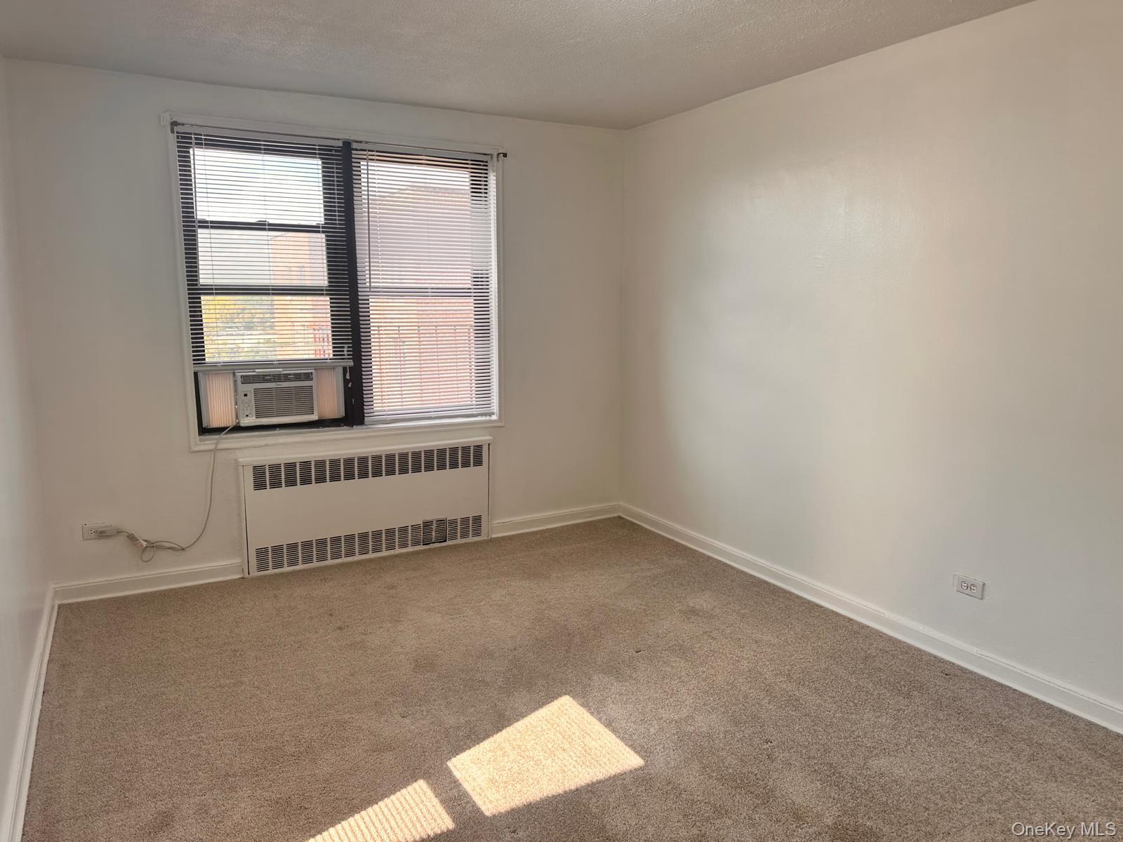 150-11 72nd Road, Unit 6F Queens, NY 11367 - Photo 24 of 31 an empty room with a window