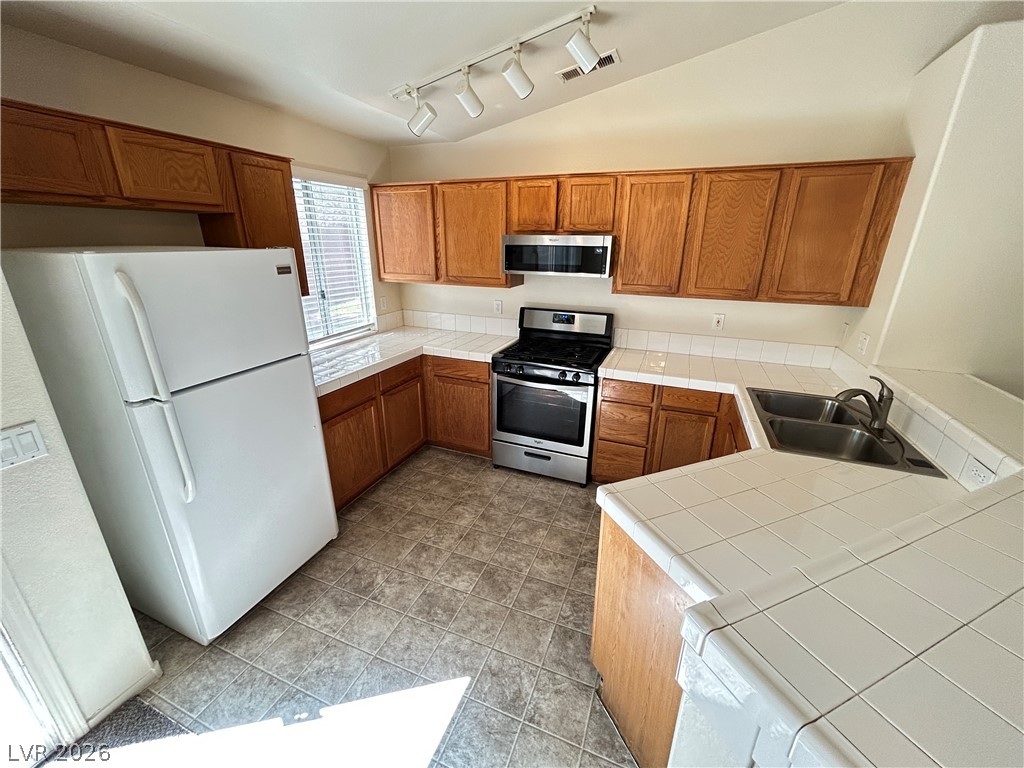1840 Montvale Las Vegas, NV 89134 - Photo 9 of 31 Functional kitchen with ample cabinetry and easy-to-maintain surfaces.