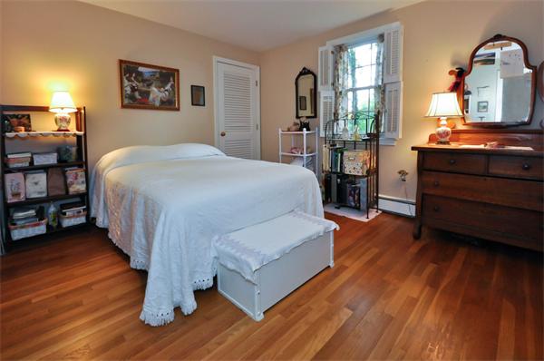 37 Oak Hill Road Wayland, MA 01778 - Photo 18 of 22 a spacious bedroom with a bed and wooden floor