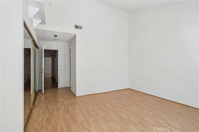 a bathroom with a granite countertop sink toilet and mirror