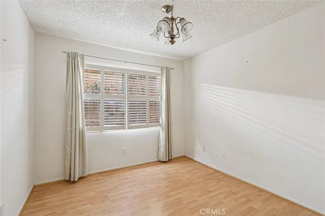 a view of a room with a chandelier fan and closet