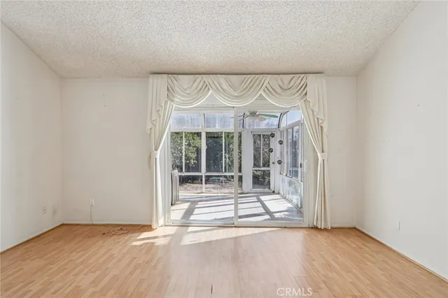 an empty room with wooden floor and door