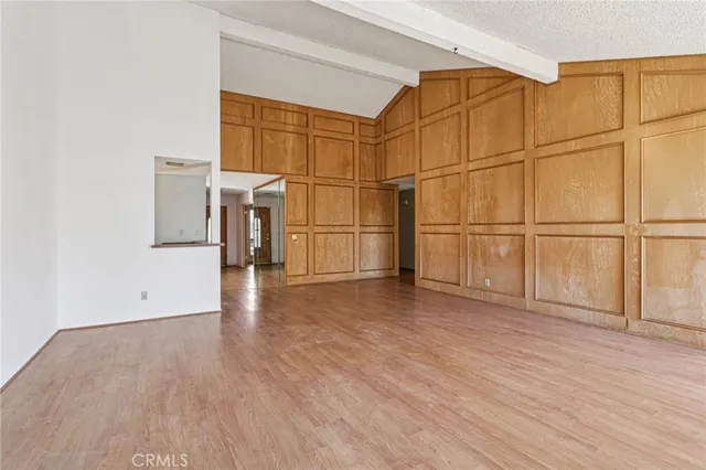 a view of empty room with wooden floor and cabinet