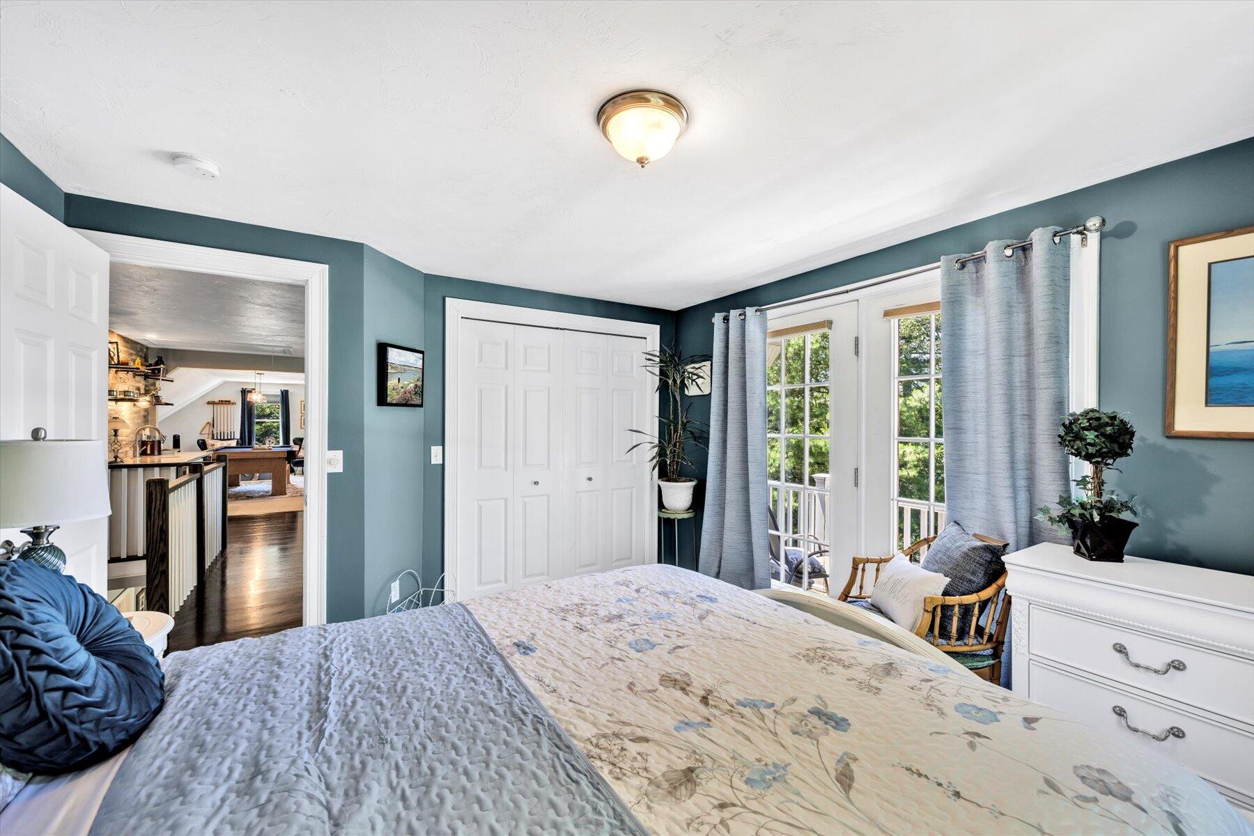 1 Ravens Nest Road Sandwich, MA 02563 - Photo 23 of 46 a bedroom with a bed and a dresser next to a window
