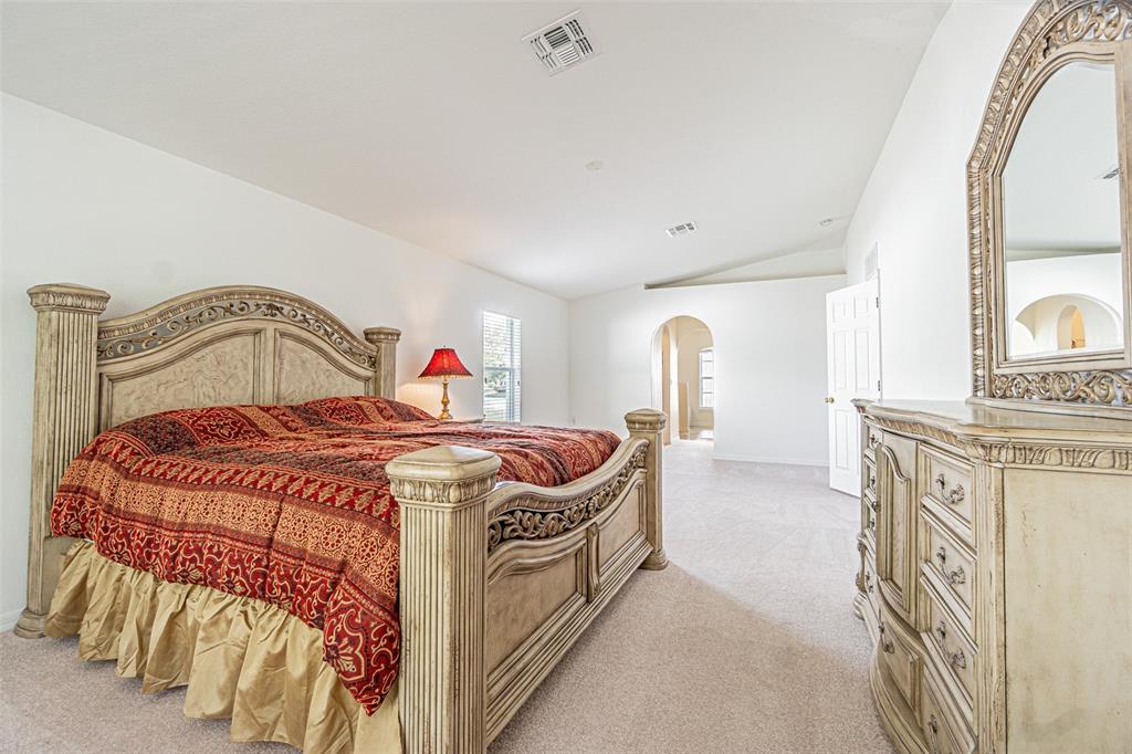 6283 Lorraine Lane Spring Hill, FL 34608 - Photo 12 of 27 a bedroom with a bed and a mirror