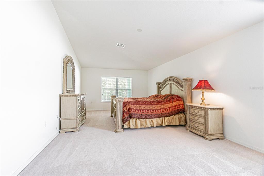 6283 Lorraine Lane Spring Hill, FL 34608 - Photo 13 of 27 a bedroom with a bed and a window