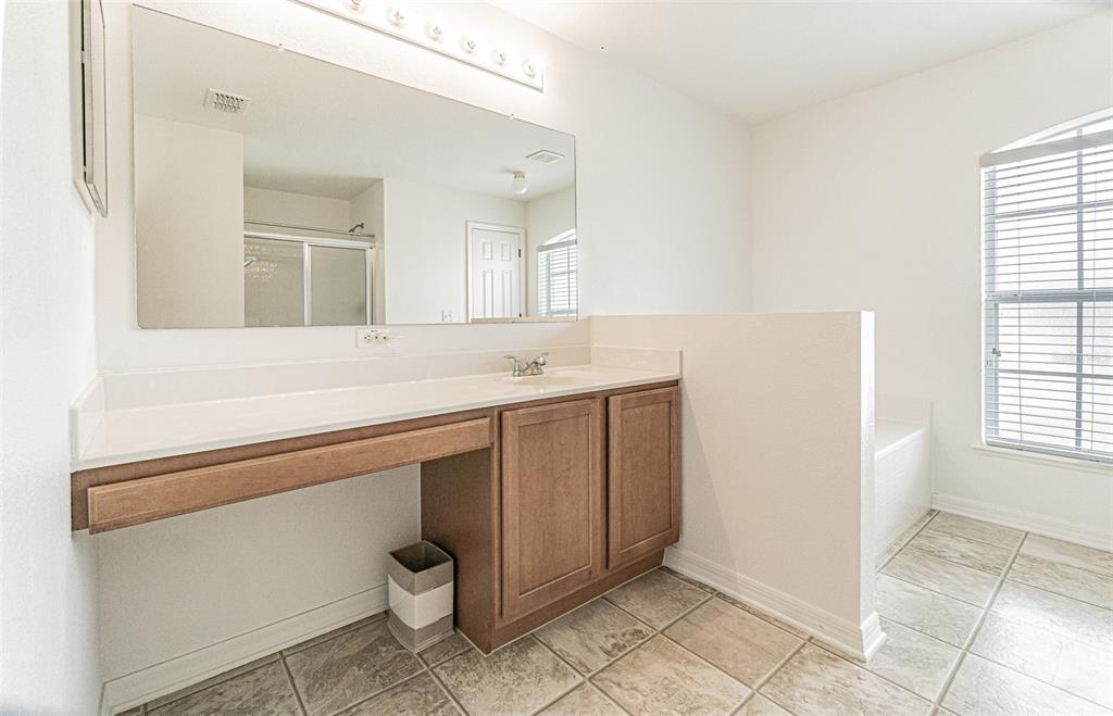6283 Lorraine Lane Spring Hill, FL 34608 - Photo 15 of 27 a spacious bathroom with a granite countertop sink a toilet and a mirror