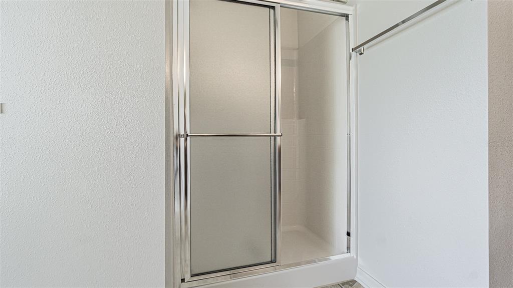 6283 Lorraine Lane Spring Hill, FL 34608 - Photo 16 of 27 a bathroom with a glass shower door