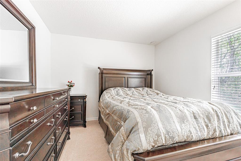 6283 Lorraine Lane Spring Hill, FL 34608 - Photo 18 of 27 a bedroom with a bed and window