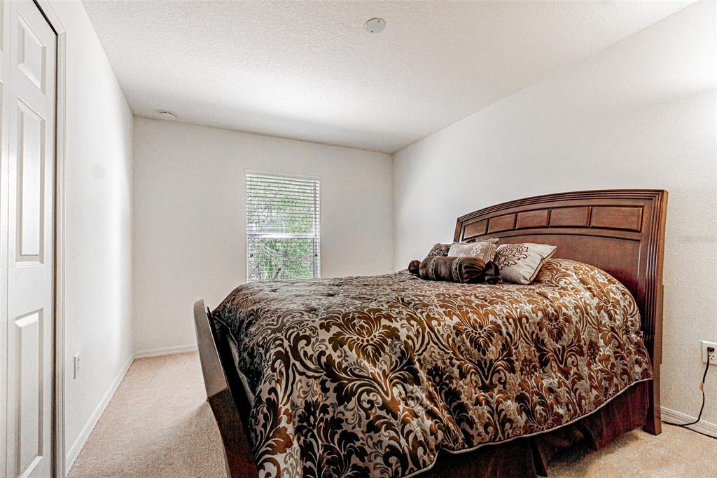 6283 Lorraine Lane Spring Hill, FL 34608 - Photo 19 of 27 a bed sitting in a bedroom next to a window