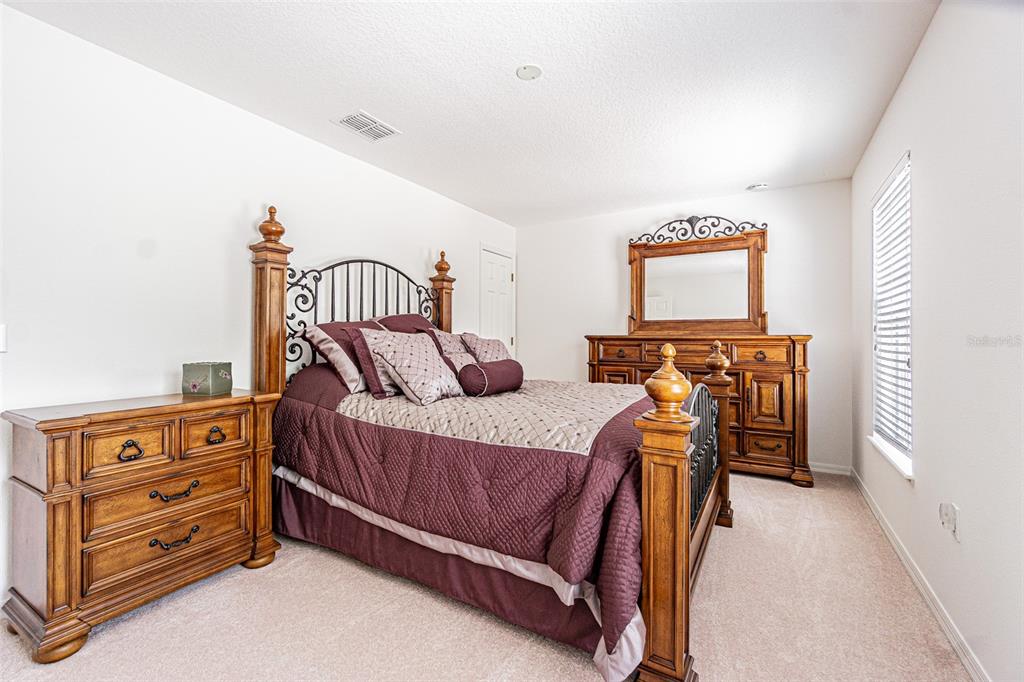 6283 Lorraine Lane Spring Hill, FL 34608 - Photo 21 of 27 a bed room with a bed and a dresser
