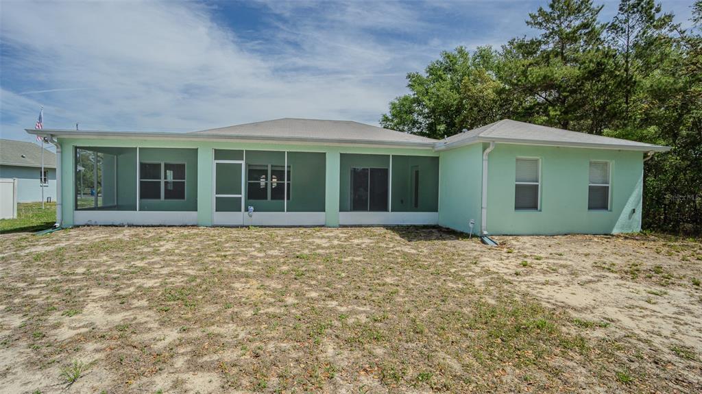 6283 Lorraine Lane Spring Hill, FL 34608 - Photo 26 of 27 front view of a house with a garden