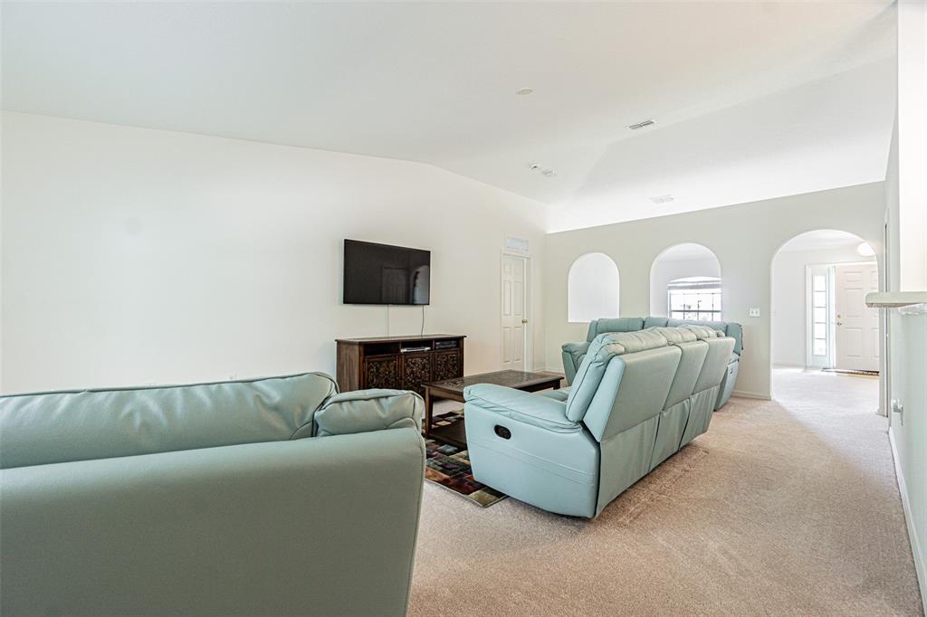 6283 Lorraine Lane Spring Hill, FL 34608 - Photo 5 of 27 a living room with furniture a fireplace and a flat screen tv