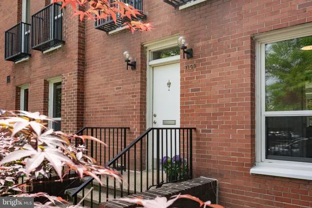 a view of a brick house with a small yard