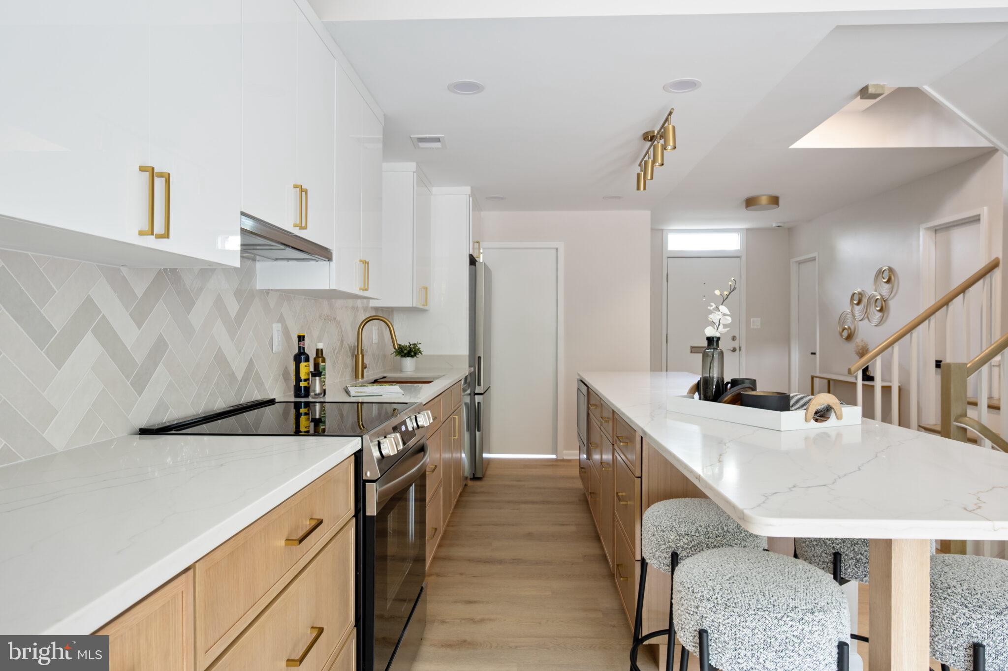 1309 4th Street Southwest, Unit TH9 Washington, DC 20024 - Photo 14 of 63 a kitchen with stainless steel appliances a sink a stove and refrigerator