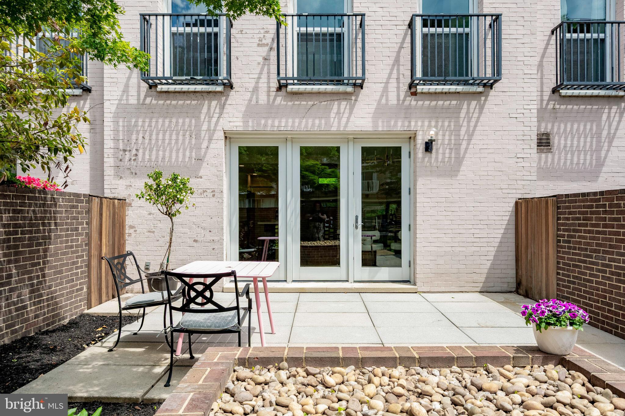 1309 4th Street Southwest, Unit TH9 Washington, DC 20024 - Photo 2 of 63 a building with table and chairs in front of it