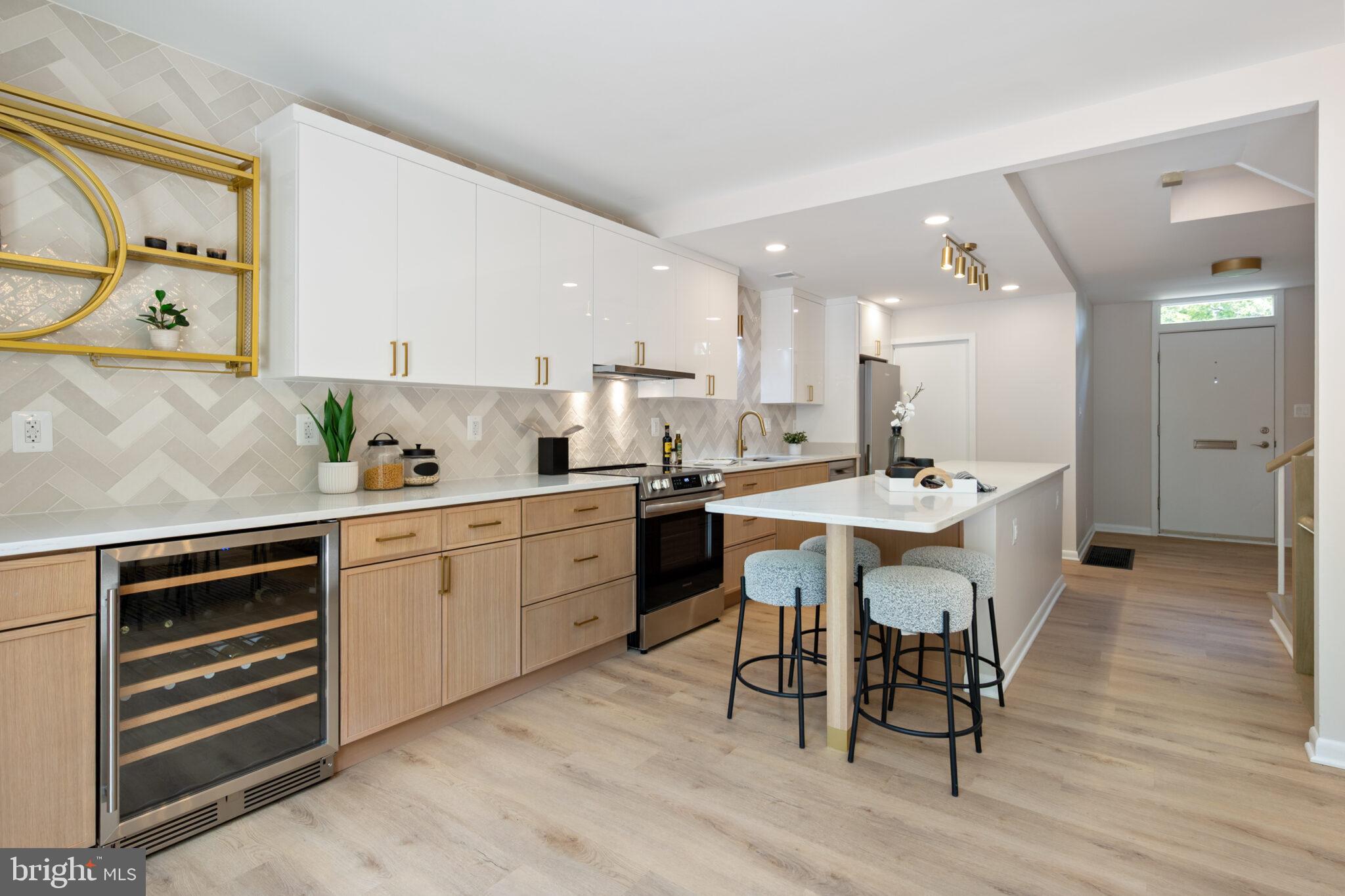 1309 4th Street Southwest, Unit TH9 Washington, DC 20024 - Photo 3 of 63 a kitchen with a table chairs sink and cabinets