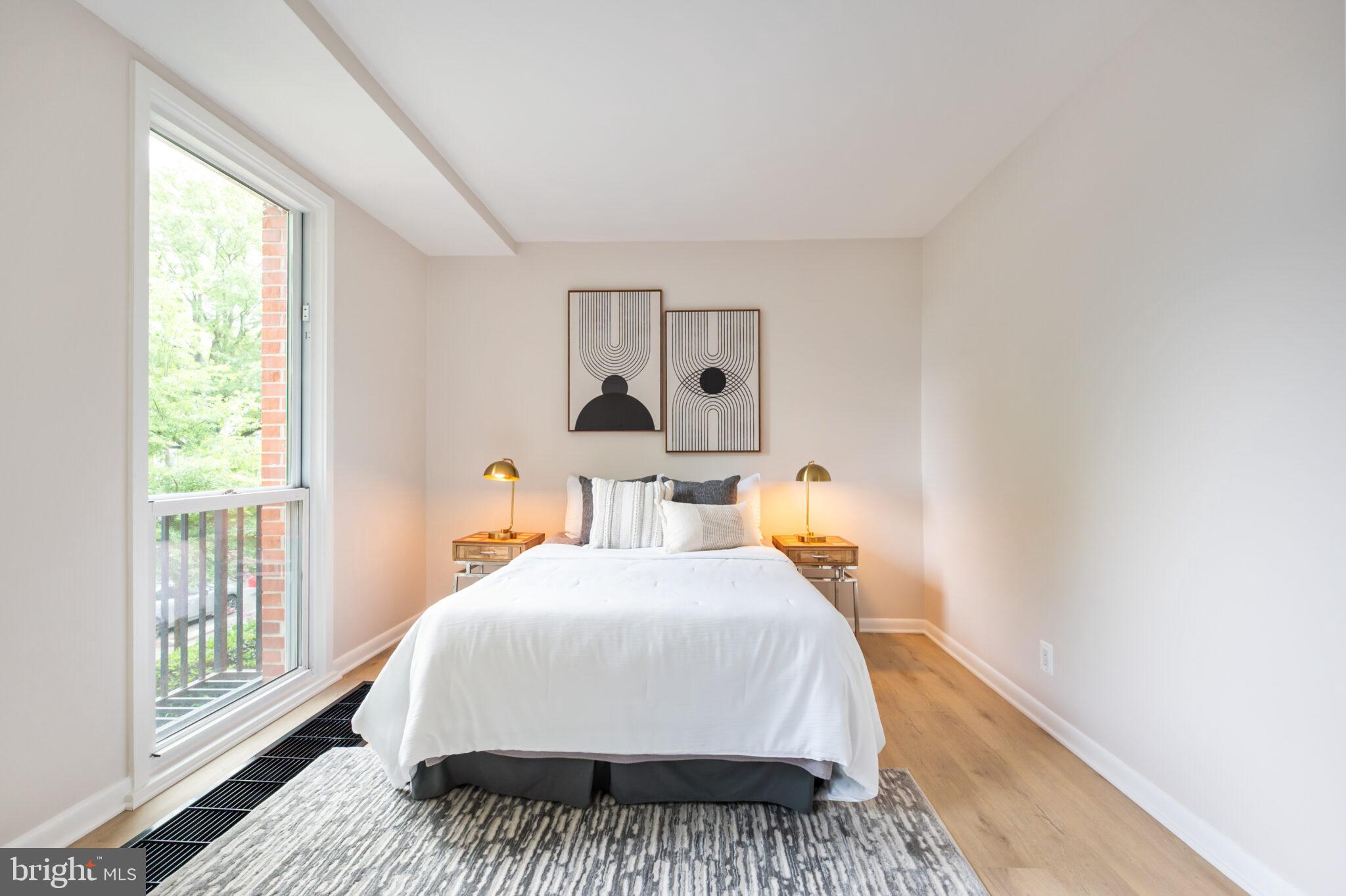 1309 4th Street Southwest, Unit TH9 Washington, DC 20024 - Photo 31 of 63 a bed sitting in a bedroom next to a window