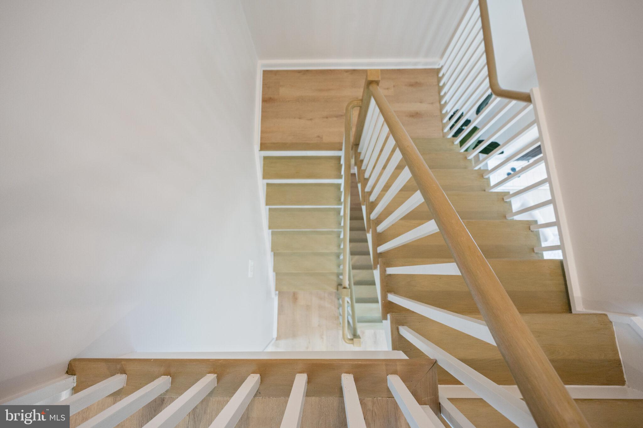 1309 4th Street Southwest, Unit TH9 Washington, DC 20024 - Photo 35 of 63 a view of staircase with white walls and a window