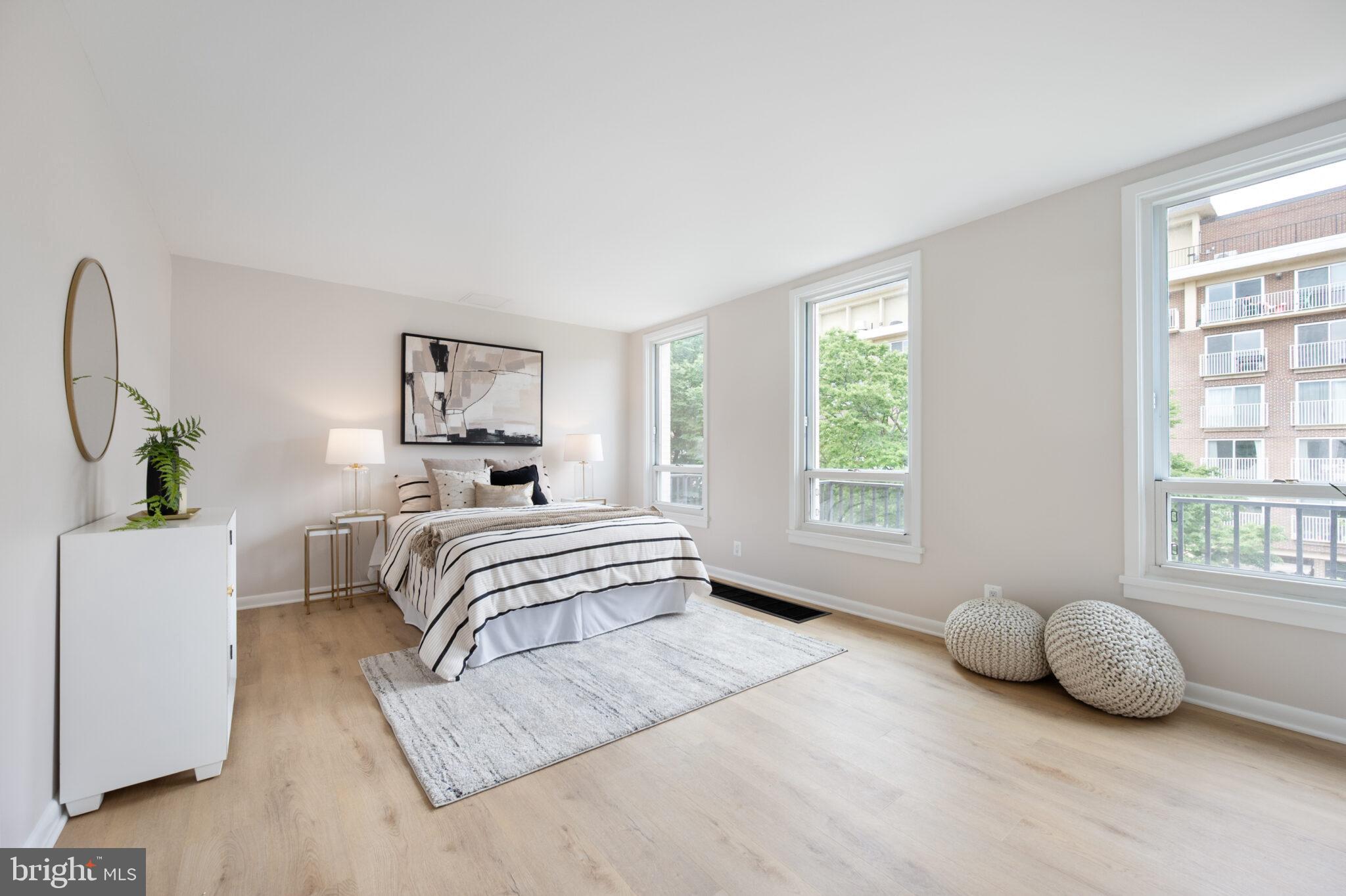 1309 4th Street Southwest, Unit TH9 Washington, DC 20024 - Photo 36 of 63 a bedroom with a bed and a large window