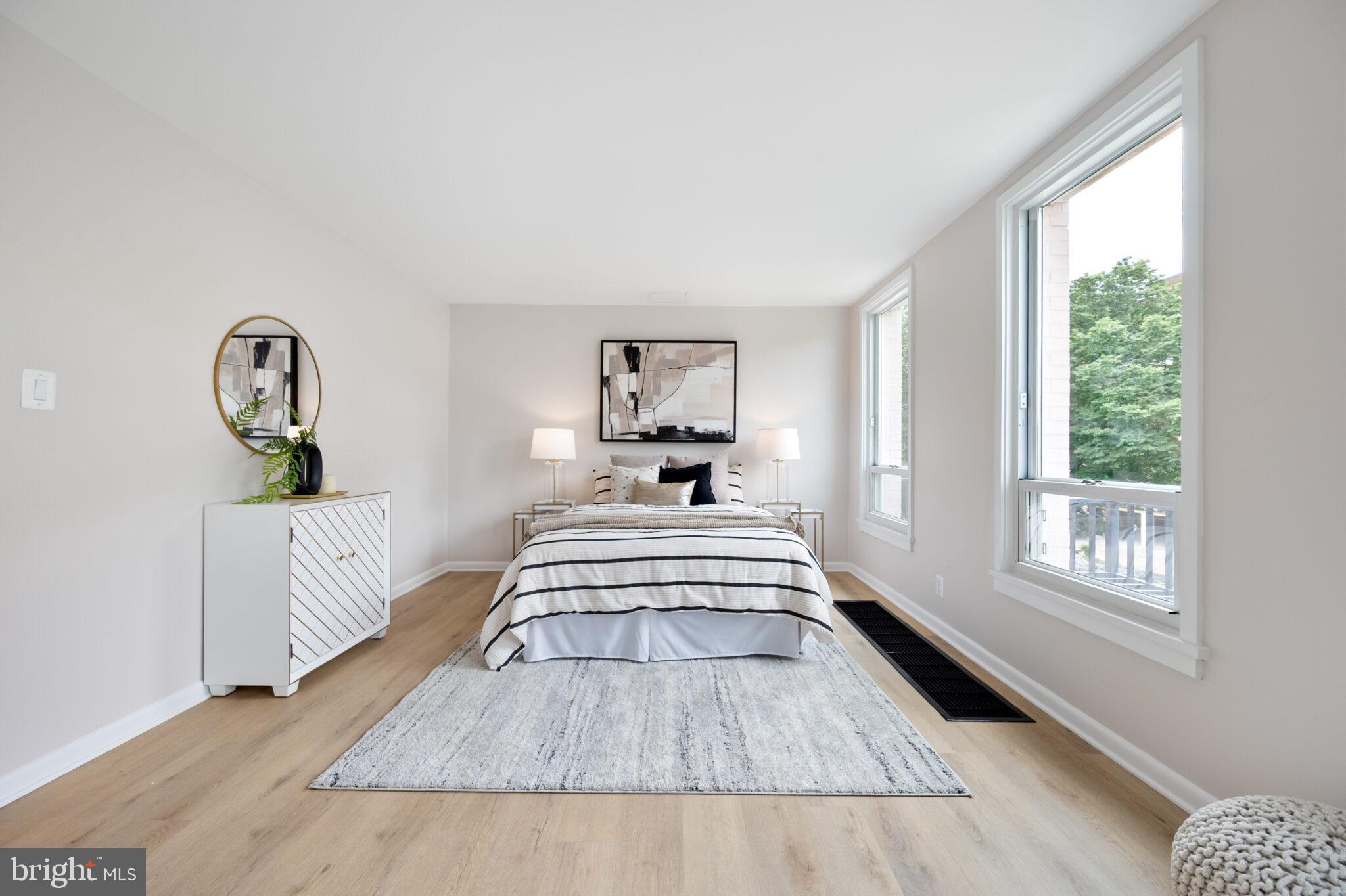 1309 4th Street Southwest, Unit TH9 Washington, DC 20024 - Photo 37 of 63 a view of a bedroom with wooden floor and bed
