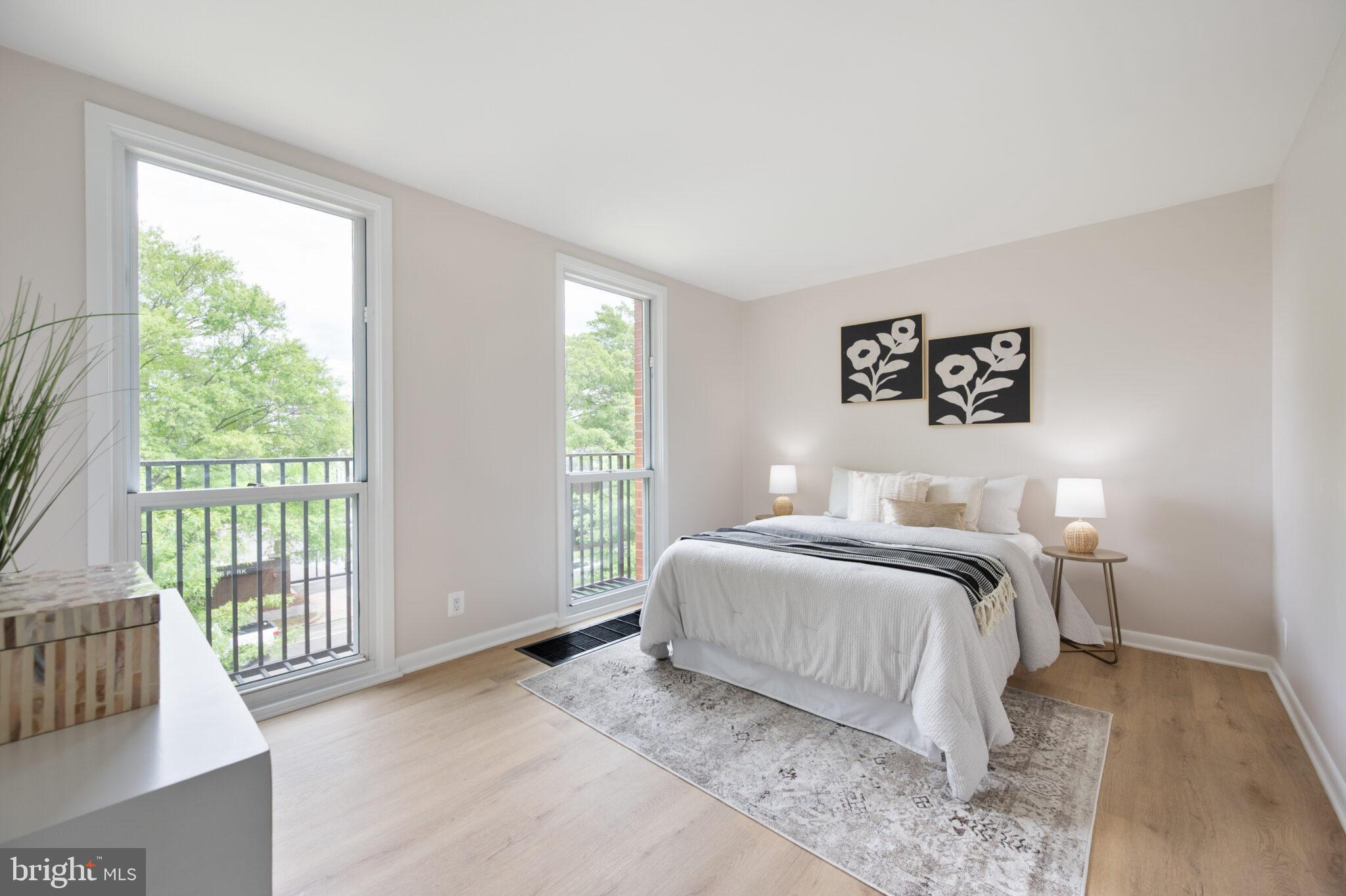 1309 4th Street Southwest, Unit TH9 Washington, DC 20024 - Photo 40 of 63 a bedroom with a bed and a large window