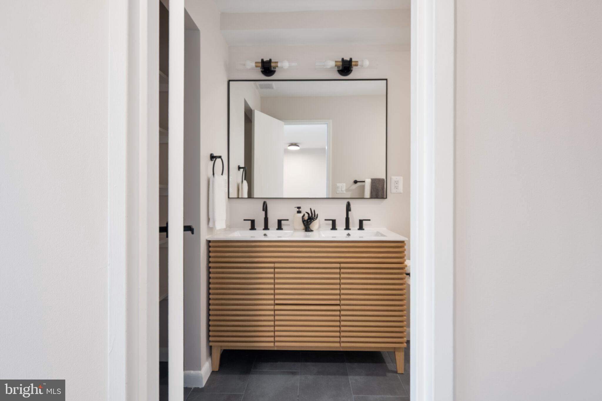 1309 4th Street Southwest, Unit TH9 Washington, DC 20024 - Photo 42 of 63 a view of a bathroom with a sink and a mirror