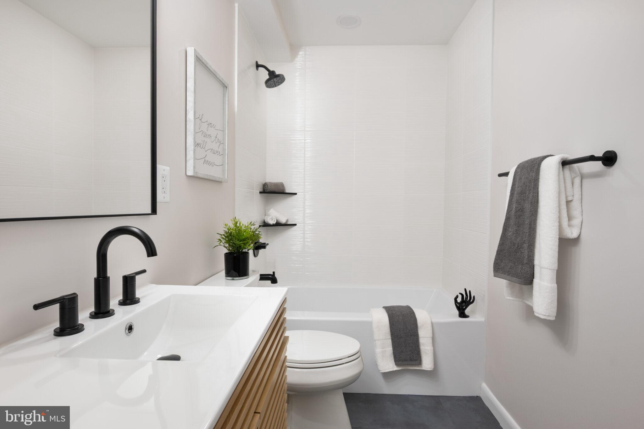 1309 4th Street Southwest, Unit TH9 Washington, DC 20024 - Photo 43 of 63 a bathroom with a sink toilet and shower