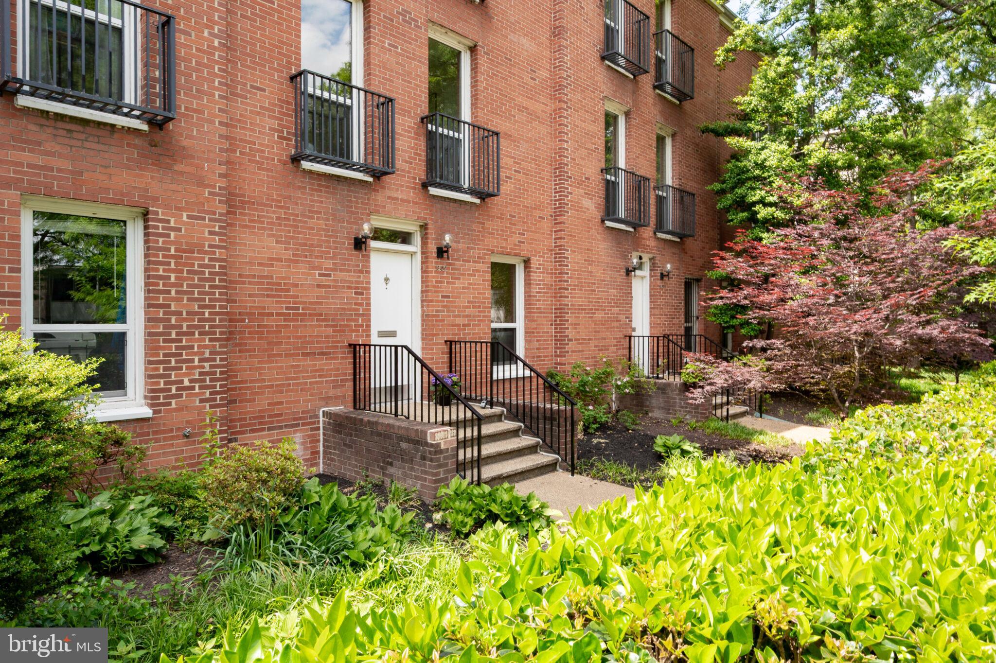 1309 4th Street Southwest, Unit TH9 Washington, DC 20024 - Photo 49 of 63 a view of a brick building next to a yard