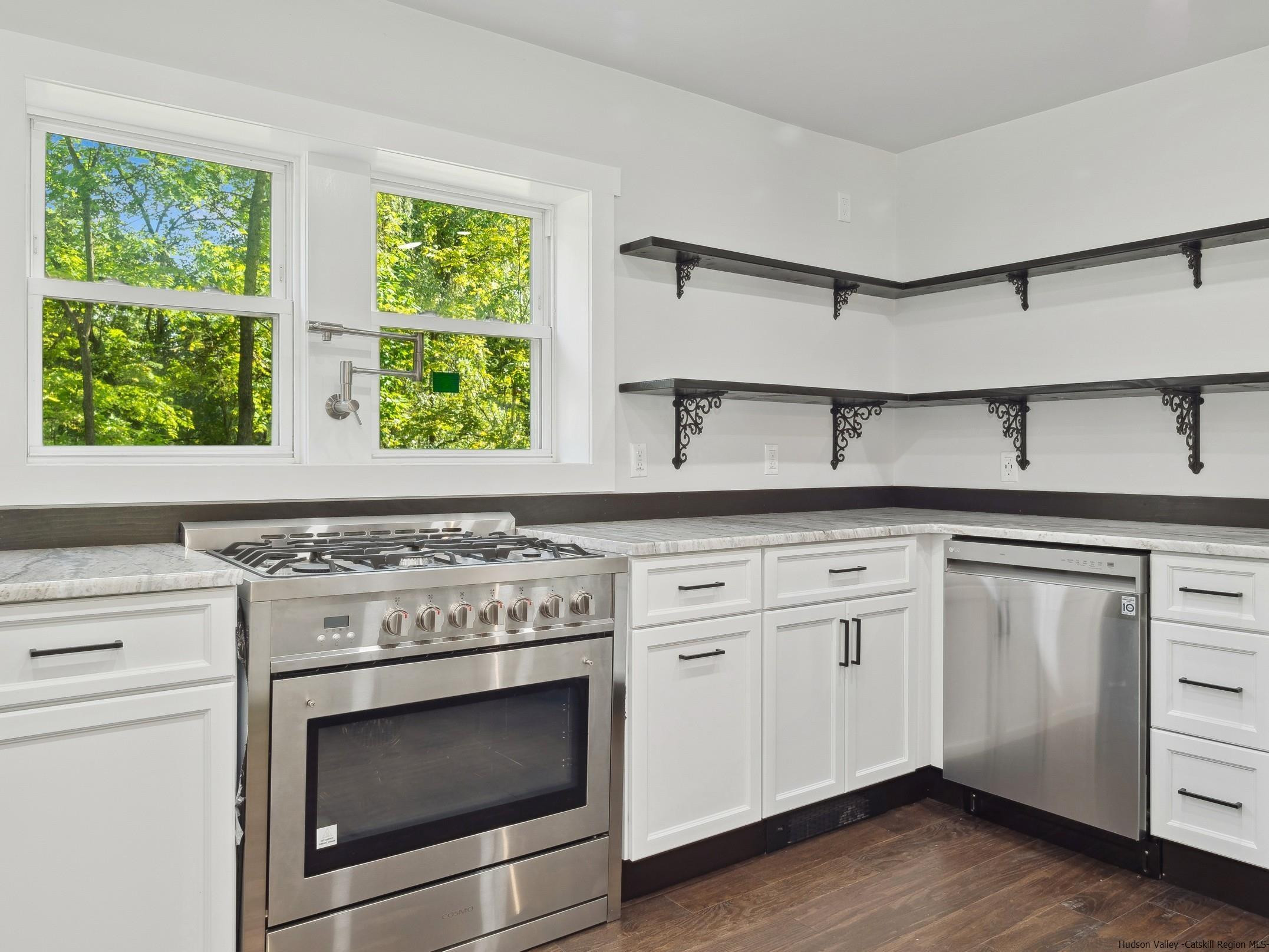 37 Towpath Road Accord, NY 12404 - Photo 11 of 29 a kitchen with granite countertop white cabinets stainless steel appliances and a large window