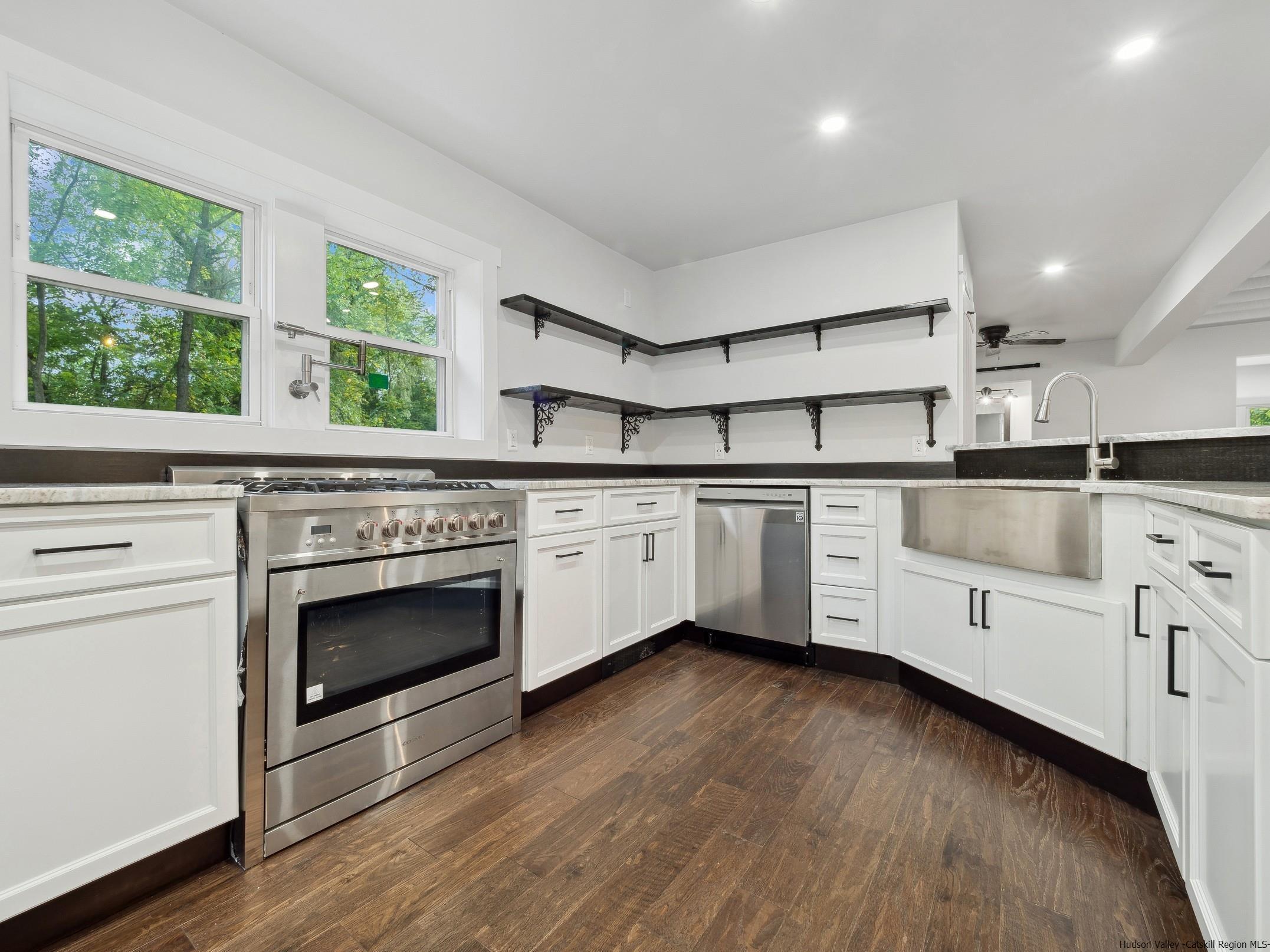 37 Towpath Road Accord, NY 12404 - Photo 12 of 29 a kitchen with stainless steel appliances white cabinets a sink and a stove