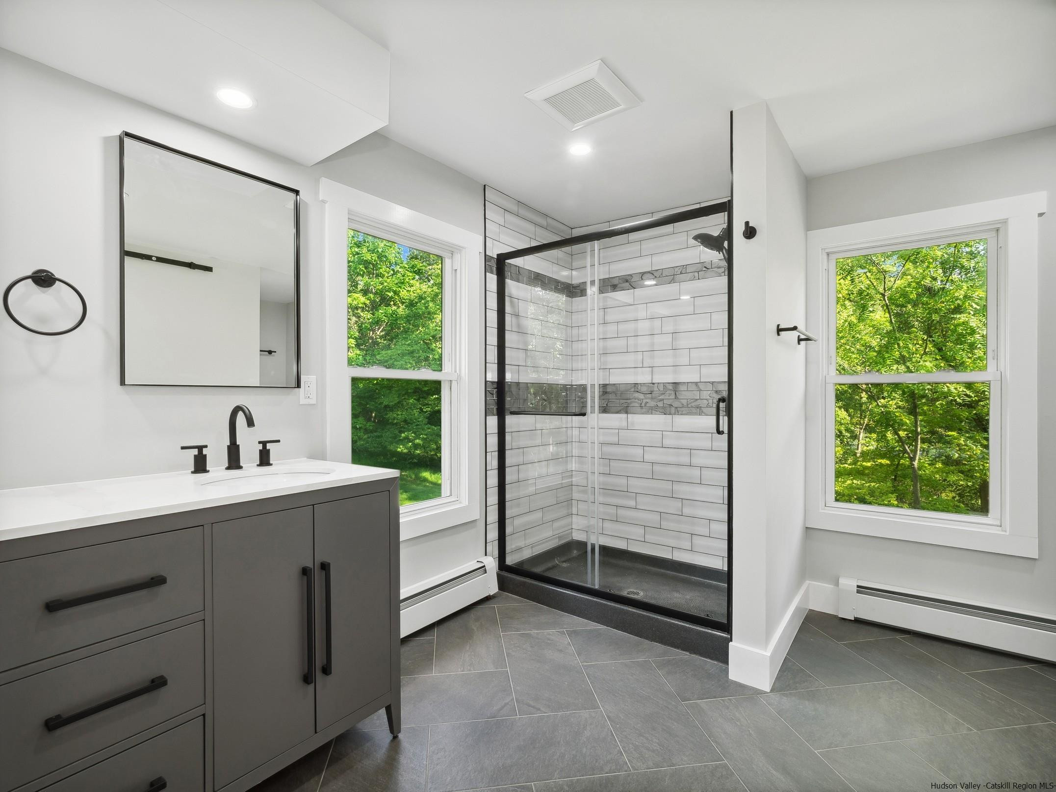 37 Towpath Road Accord, NY 12404 - Photo 18 of 29 a bathroom with a shower sink and mirror
