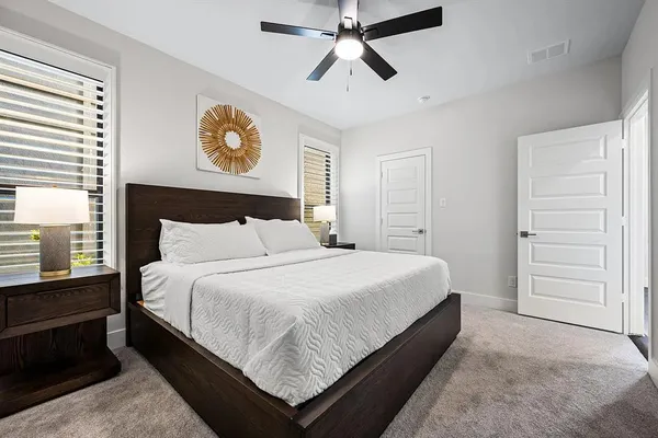 a bedroom with a bed and a ceiling fan