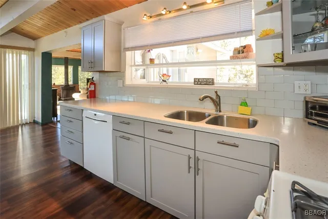 a kitchen with sink cabinets and wooden floor