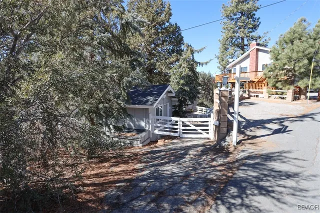 a view of a house with a yard covered in snow
