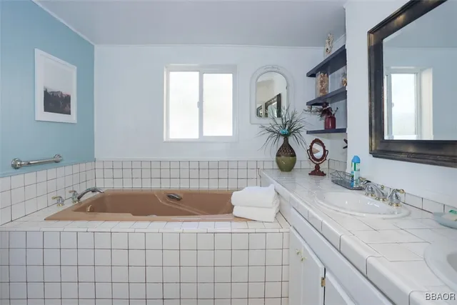 a bathroom with a sink a vanity and a bathtub