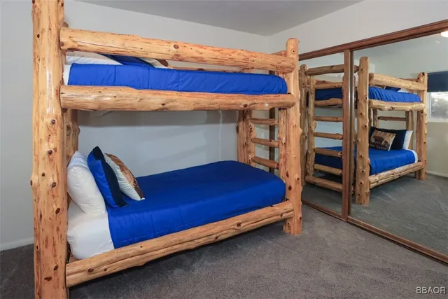 a bed sitting in a bedroom next to a window