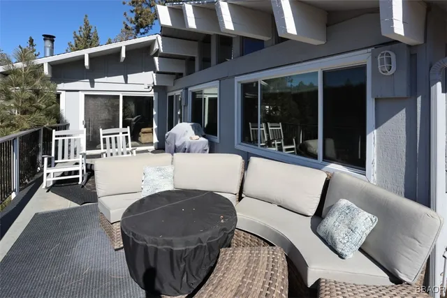 a view of a patio with couches table and chairs and potted plants