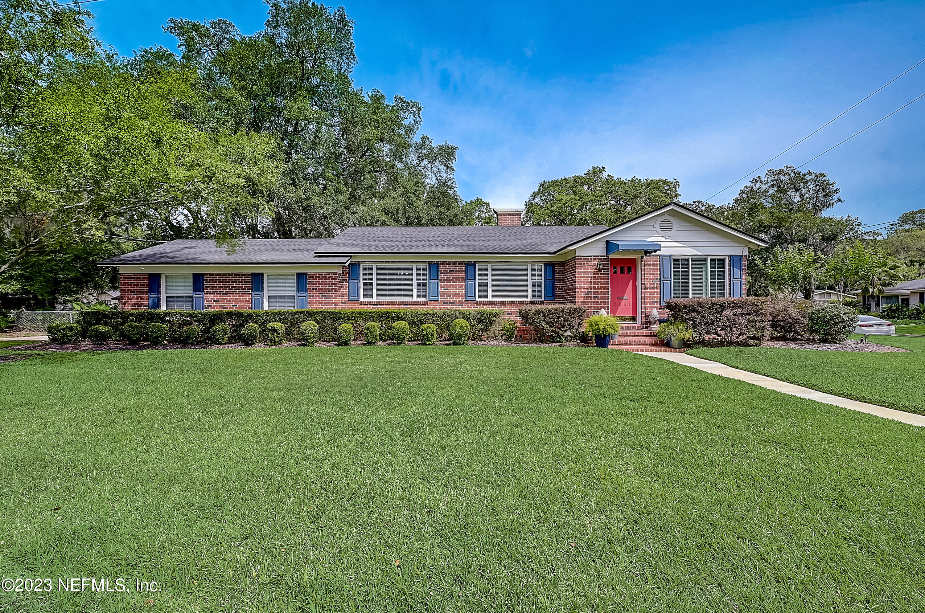 2631 Jolly Road Jacksonville, FL 32207 - Photo 5 of 42 a front view of a house with a yard and green space