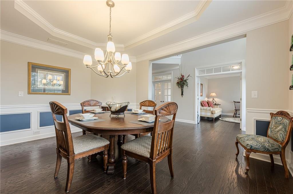 5515 Cheatam Avenue Cumming, GA 30040 - Photo 13 of 99 a dining room with furniture a chandelier and wooden floor