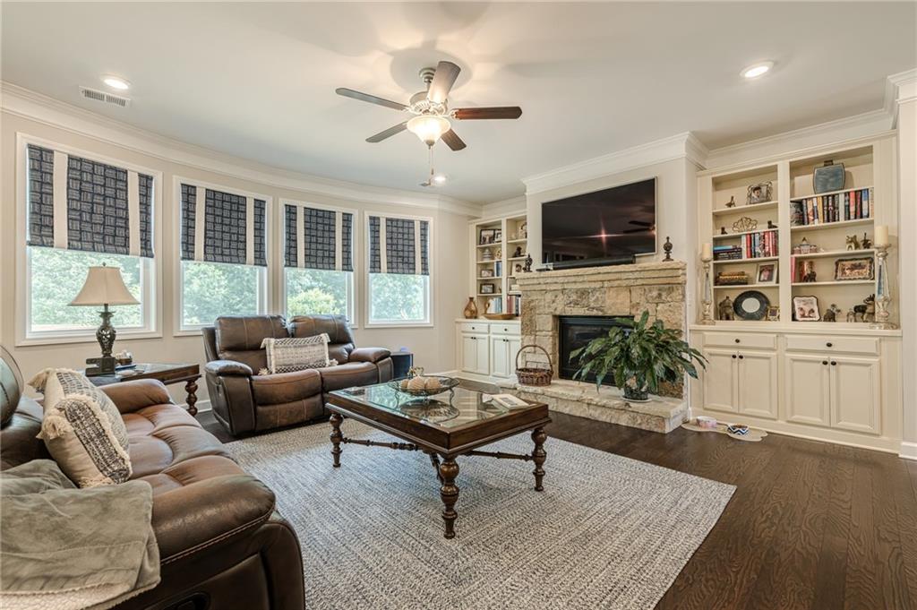 5515 Cheatam Avenue Cumming, GA 30040 - Photo 16 of 99 a living room with furniture a flat screen tv and a fireplace