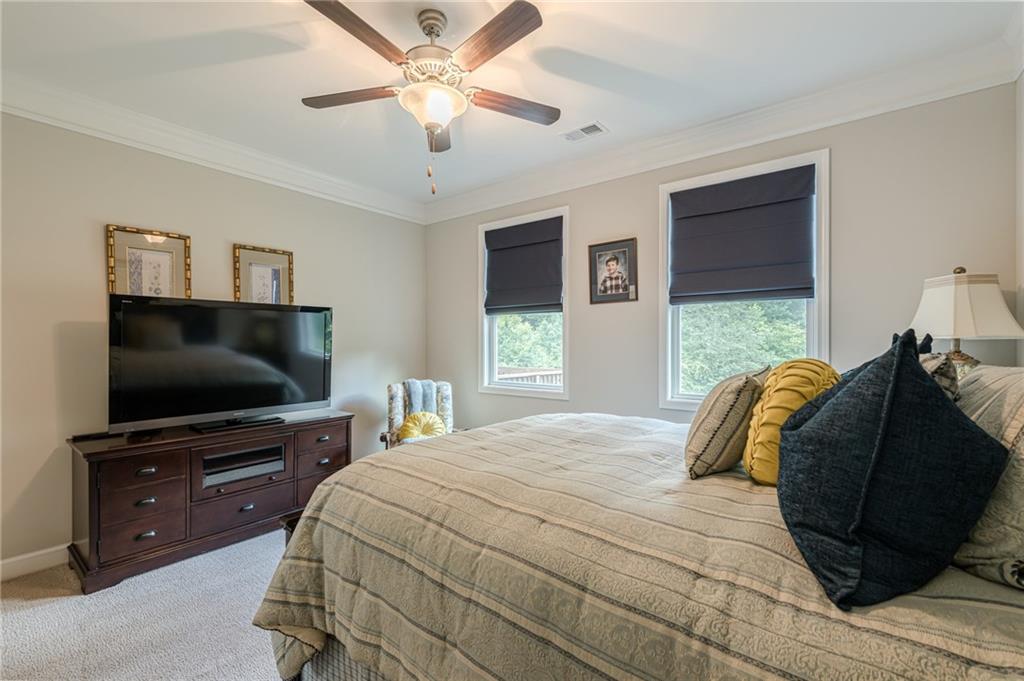 5515 Cheatam Avenue Cumming, GA 30040 - Photo 34 of 99 a bedroom with a bed and a flat screen tv