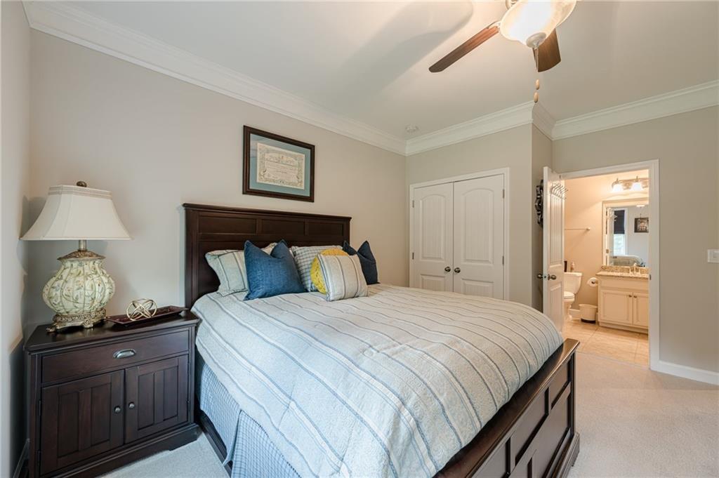 5515 Cheatam Avenue Cumming, GA 30040 - Photo 35 of 99 a bedroom with a bed and wooden floor