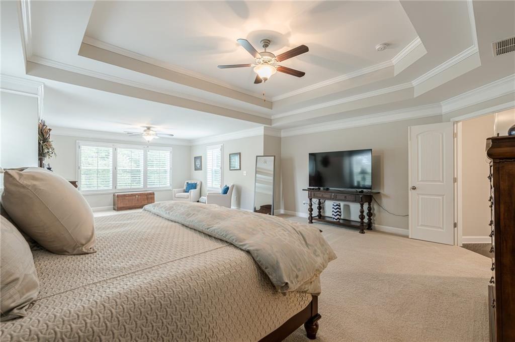 5515 Cheatam Avenue Cumming, GA 30040 - Photo 38 of 99 a bedroom with a bed a flat screen tv and a couch