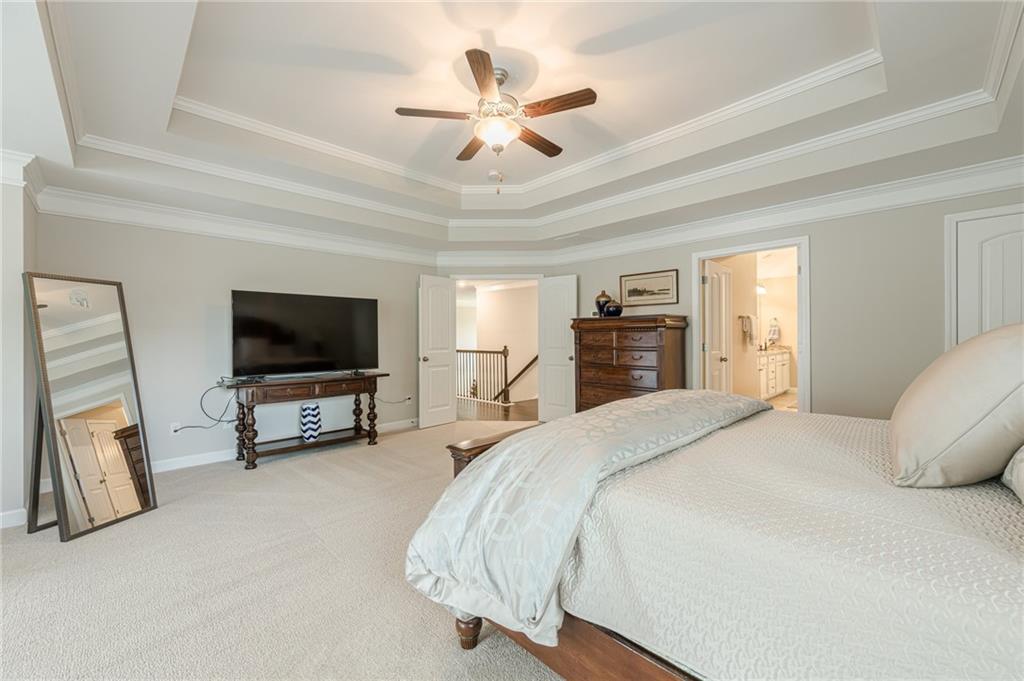 5515 Cheatam Avenue Cumming, GA 30040 - Photo 40 of 99 a spacious bedroom with a bed and a flat screen tv